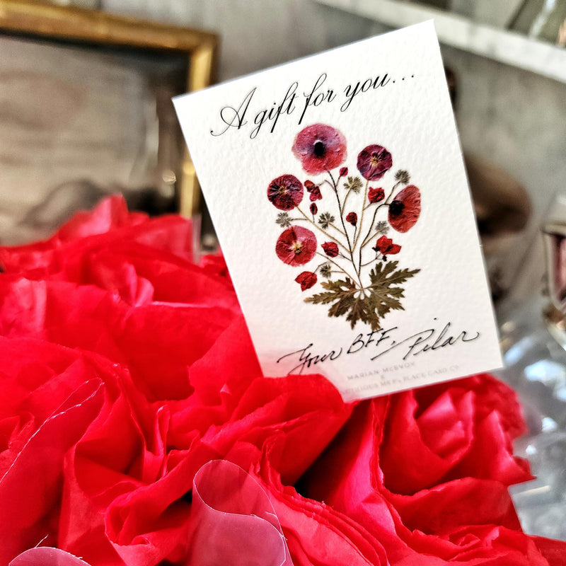 Mr. P's Pantry's jam trio "bouquet" features 3 jams wrapped in red tissue paper and cellophane that closely resembles a bouquet of flowers, included is a pressed poppies gift note.