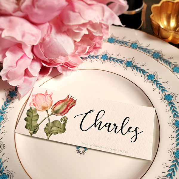 The Punctilious Mr. P's place card co. 'Parrot Tulips' laydown size custom place cards on black and gold china tablescape with fresh flowers and vintage silver cutlery