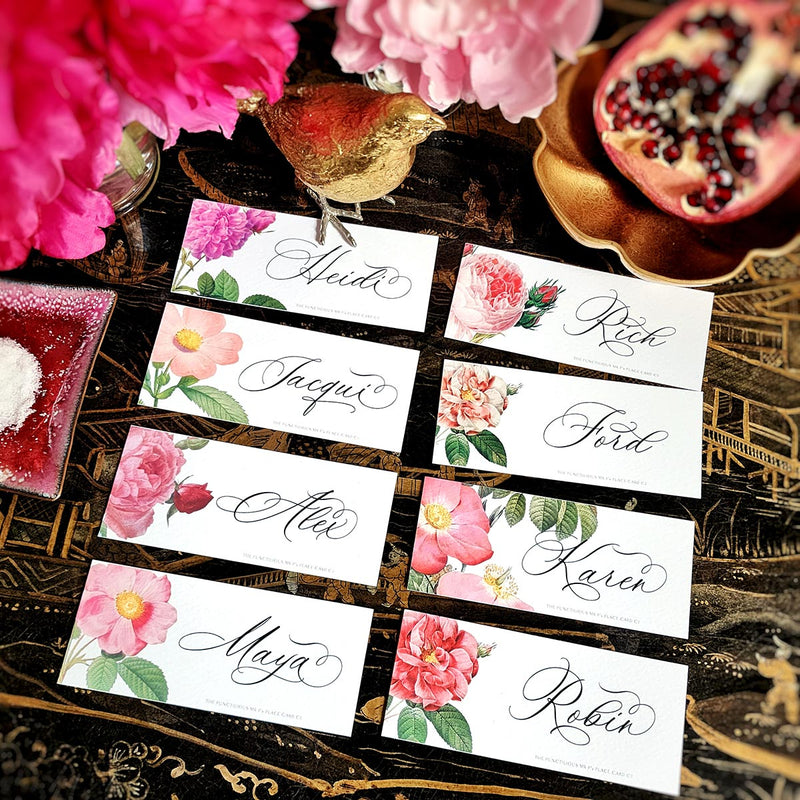 Showing all 8 images of The Punctilious Mr. P's 'Rose Garden' laydown size custom place cards on black and gold china tablescape with fresh flowers, pomegranate and bamboo