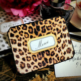 A leopard-print note card with clipped corners and a gold-framed cartouche reading "Merci" in script, from the Punctilious Mr. P's Place Card Company