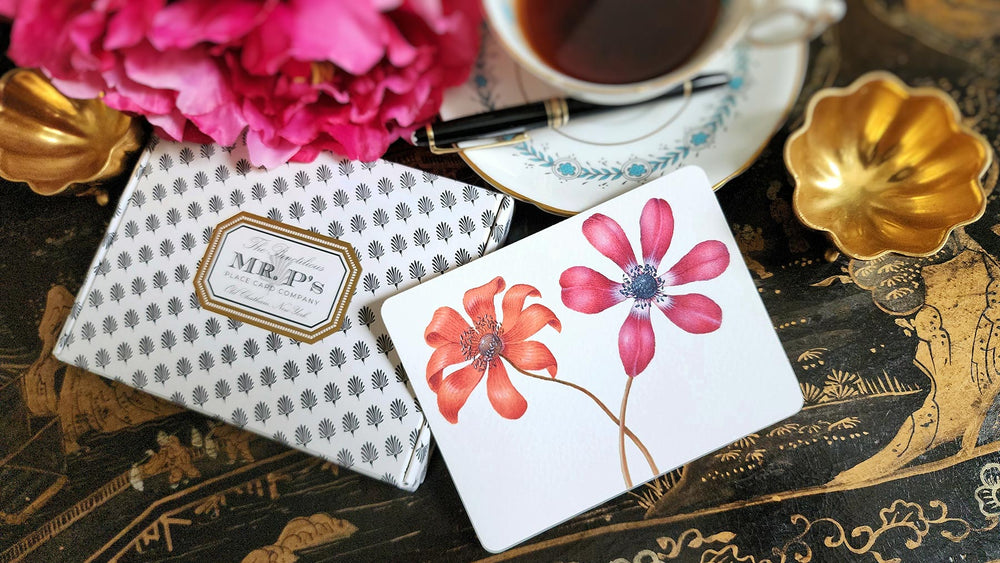The Punctilious Mr. P's Place Card Co. 'Anemones' custom note card pack with a montblanc fountain pen on a chinoiserie table with cup of tea and large beautiful peony flower