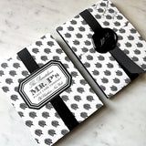 Pack of Mr. P’s illustrated bookplates showing the front and back of their iconic black and white anthemion packaging, closed with a black wax seal and grosgrain ribbon