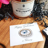 The Punctilious Mr. P's Place Card Co. "The Lover's Eye- Pearl" Custom Gift Notes on a chinoiserie table with marmalade jam, cutting board and fresh flowers