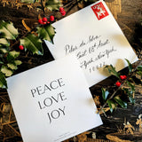The Punctilious Mr. p's place card co. collab with sarah v battle showing back of holiday card that reads: peace, love, joy