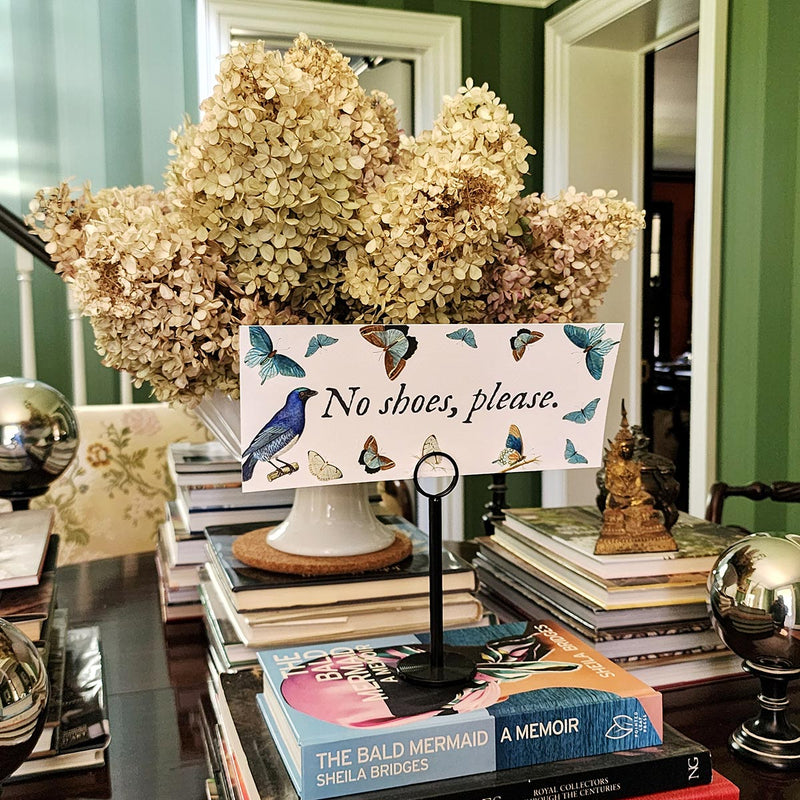 The Punctilious Mr. P's Place Card Co. "Blue Butterflies Custom Illustrated Signage" on a black stand that says "no shoe, please." to let your guests know your house rules, or to welcome them to your wedding event