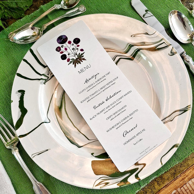 Marian McEvoy's bistro size pressed poppy Custom  menu sits atop Christopher Spitzmiller's green marbleized dinner plate that makes a beautiful tablescape