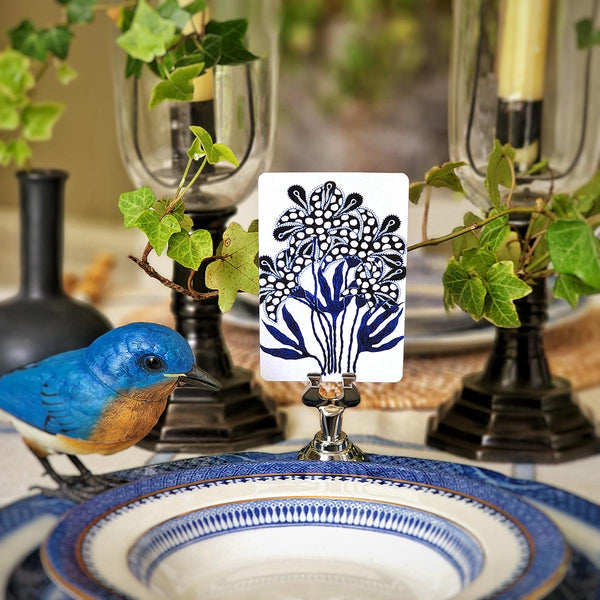 Marian McEvoy x The Punctilious Mr. P's Place Card Co collab with blue and white drawings of botanicals and floral motifs on custom place cards on a beautiful tablescape