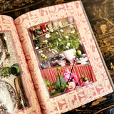Casa Cabana book by Martina Mondadori showing page with a dinner table filled with flowers and a striped tablecloth