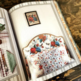 Casa Cabana book by Martina Mondadori showing page with floral headboard and striped wallpaper on walls