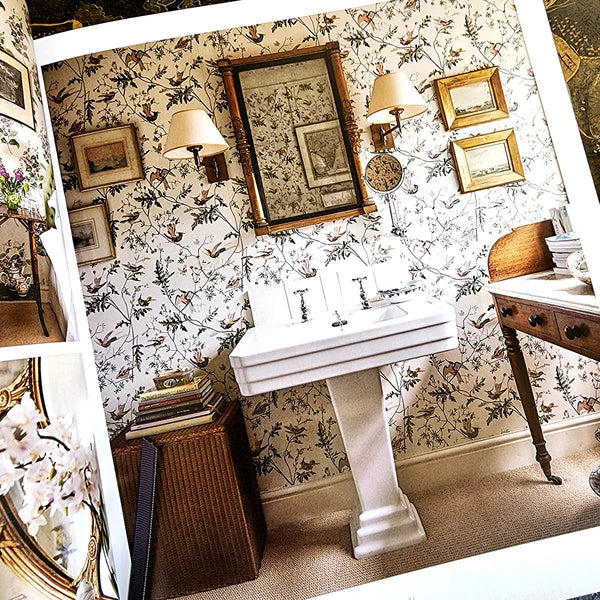 Modern English Interiors by todhunter earle book showing a delightful powder room with printed wallpaper and antique gold framed mirrors