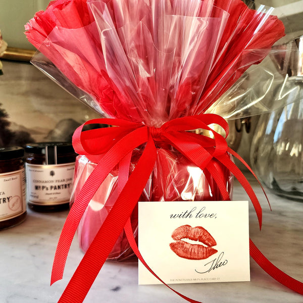Mr. P's Pantry's jam trio "bouquet" features 3 jams wrapped in red tissue paper and cellophane that closely resembles a bouquet of flowers, included is a kisses gift note. 