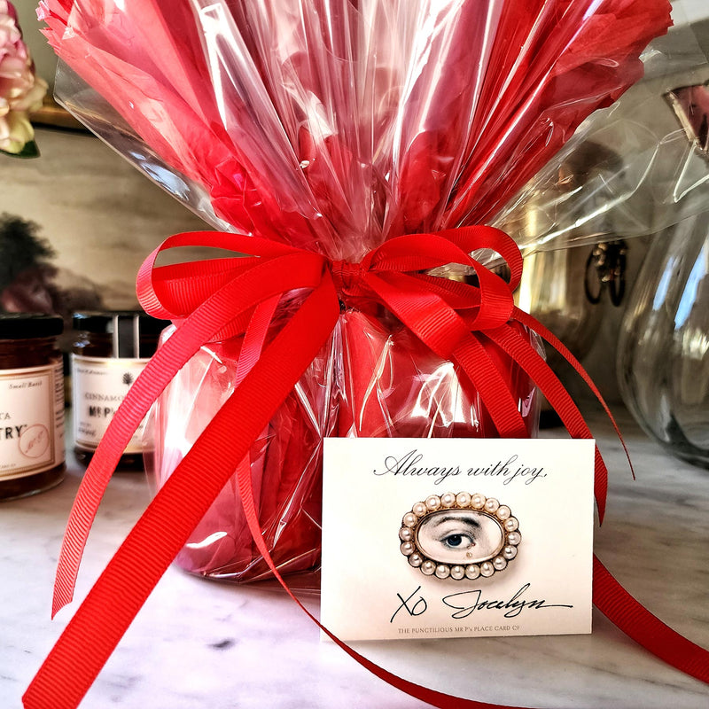Mr. P's Pantry's jam trio "bouquet" features 3 jams wrapped in red tissue paper and cellophane that closely resembles a bouquet of flowers, included is a lover's eye gift note.