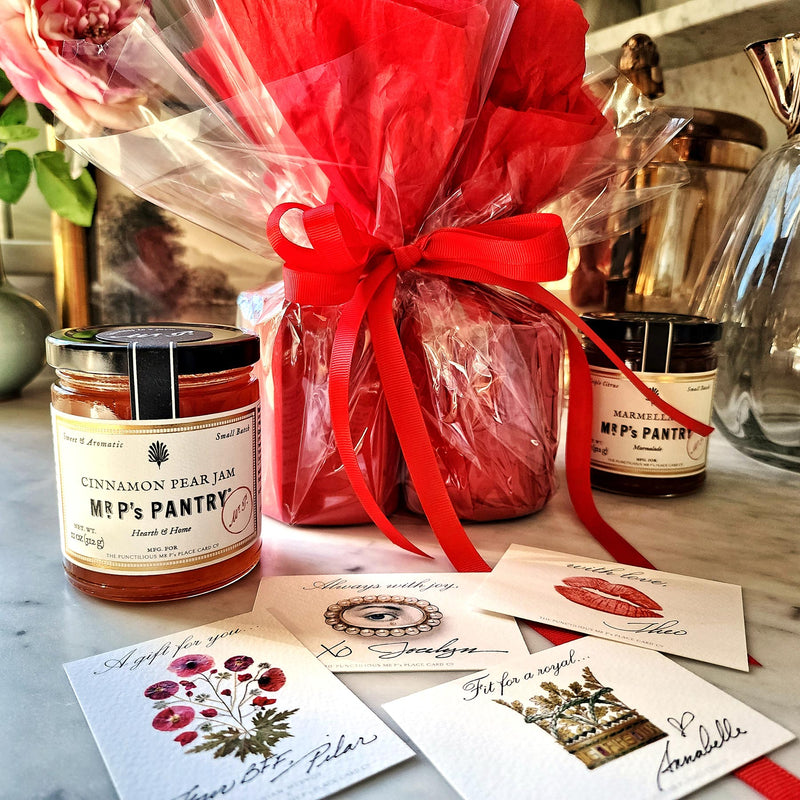 Mr. P's Pantry's jam trio "bouquet" features 3 jams wrapped in red tissue paper and cellophane that closely resembles a bouquet of flowers, showing all 4 gift notes.
