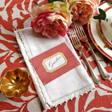 The Punctilious Mr. P's place card co. 'Envoy- Brique' shaded of reds laydown event size custom place cards on printed tablecloth tablescape with fresh flowers and vintage silver cutlery