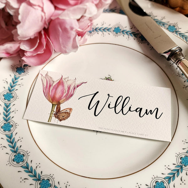 The Punctilious Mr. P's place card co. 'Blossoms' laydown size custom place cards on black and gold china tablescape with fresh flowers and vintage silver cutlery