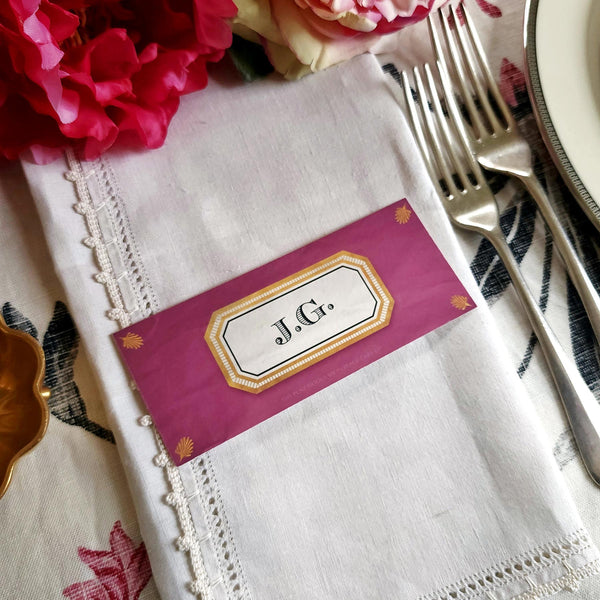 The Punctilious Mr. P's place card co. 'Envoy- Aubergine' shaded of purples laydown size custom place cards on printed tablecloth tablescape with fresh flowers and vintage silver cutlery
