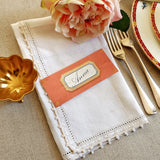 The Punctilious Mr. P's place card co. 'Envoy- Melon' shades of oranges laydown size custom place cards on printed tablecloth tablescape with fresh flowers and vintage silver cutlery
