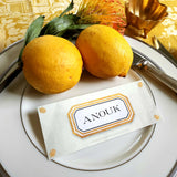 The Punctilious Mr. P's place card co. 'Envoy- Soleil' shades of yellows laydown size custom place cards on printed tablecloth tablescape with fresh flowers and vintage silver cutlery
