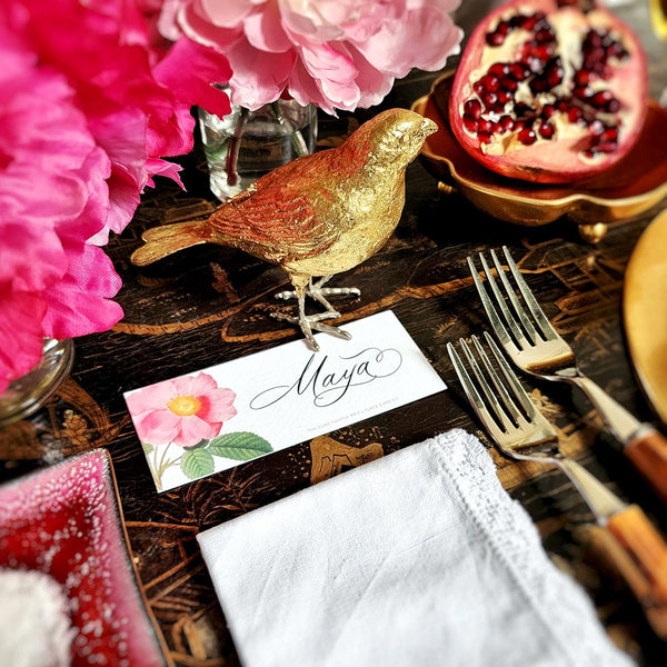 The Punctilious Mr. P's place card co. 'Rose Garden' laydown size custom place cards on black and gold china tablescape with fresh flowers, pomegranate and bamboo cutlery