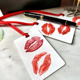 The Punctilious Mr. P's Place Card Co. 'Kisses' custom Gift Tags on a white marble table