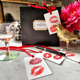 The Punctilious Mr. P's Place Card Co. 'Kisses' custom Gift Tags tied to a black bag
