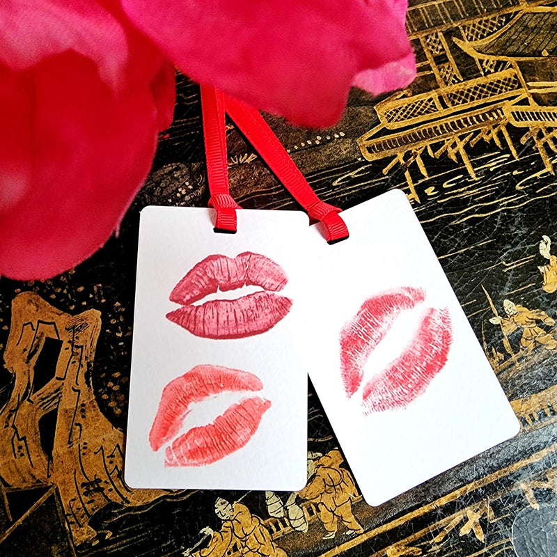 The Punctilious Mr. P's Place Card Co. 'Kisses' custom Gift Tags tied to a black bag