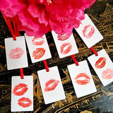 showing all 8 of The Punctilious Mr. P's Place Card Co. 'Kisses' custom Gift Tags on a chinoiserie table