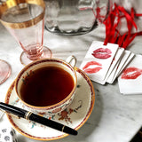 The Punctilious Mr. P's Place Card Co. 'Kisses' custom Gift Tags on a white marble table with a cup of tea