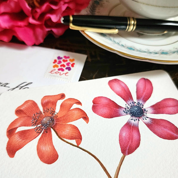 detail of The Punctilious Mr. P's Place Card Co. 'Anemones' custom note card pack with a montblanc fountain pen on a chinoiserie table with cup of tea and large beautiful peony flower