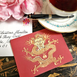The Punctilious Mr. P's Place Card Co. 'Radiant Dragon-Cinnabar' custom note card pack with a montblanc fountain pen on a chinoiserie table with cup of tea and large beautiful peony flower