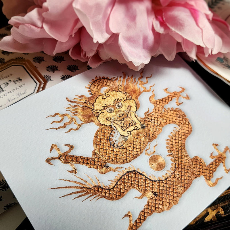 The Punctilious Mr. P's Place Card Co. 'Radiant Dragon' custom note card pack with a montblanc fountain pen on a chinoiserie table with cup of tea and large beautiful peony flower