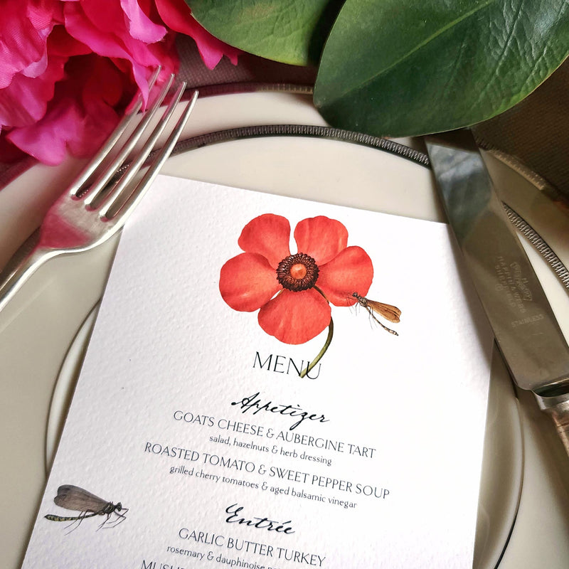 The Punctilious Mr. P's Place Card Co. "Blossoms" menu card on simple white china decorated with magnolia leaves, bright red peony and vintage cutlery