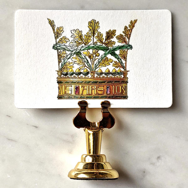 The Punctilious Mr. P's Place Card Co. 'Coronet Nouveau' custom place card on top of a marble tabletop