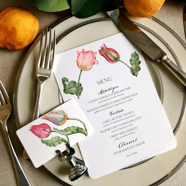 The Punctilious Mr. P's Place Card Co. "Parrot Tulips" menu card on simple white china decorated with magnolia leaves, real oranges and vintage cutlery