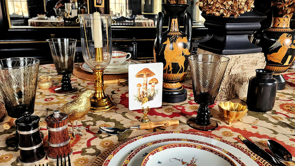 Mr. P's thanksgiving table -2023 featuring mushroom place cards, greek vases on suzani cloth table