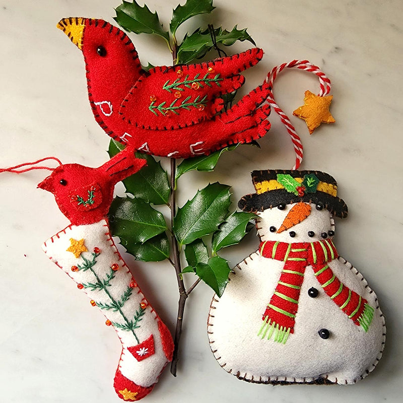 THE PUNCTILIOUS MR. p's place card co. frosty trio christmas ornaments which includes a snowman, a red peace bird and white stocking