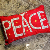 The punctilious mr. p's place card co. red 'peace' pillow showing the letters P-E-A-C-E Sewn on by hand, crowned with an appliqued white dove