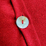 detail of the pearl button on the peace pillow