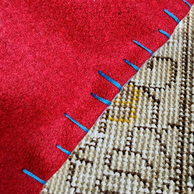 detail of the whipstitching on the edge of the peace pillow