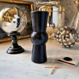 medium pillar candles on white marble table with a stainless steel orb and base and a small box of matches