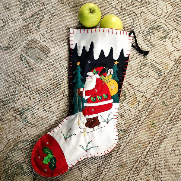 THE PUNCTILIOUS MR. p's place card co. skiing santa christmas stocking of santa skiing downhill in a winter wonderland scene on a tapestry rug