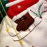 detail of THE PUNCTILIOUS MR. p's place card co. skiing santa christmas stocking showing his ski boots and poles