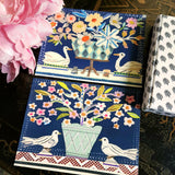 The Punctilious Mr. P x Sarah V Battle "Doves & Swans" fine note card set featuring collage reproductions of her original artwork, on chinoiserie table with Mr. P's I conic black and white anthemion print. montblanc fountain pen resting by