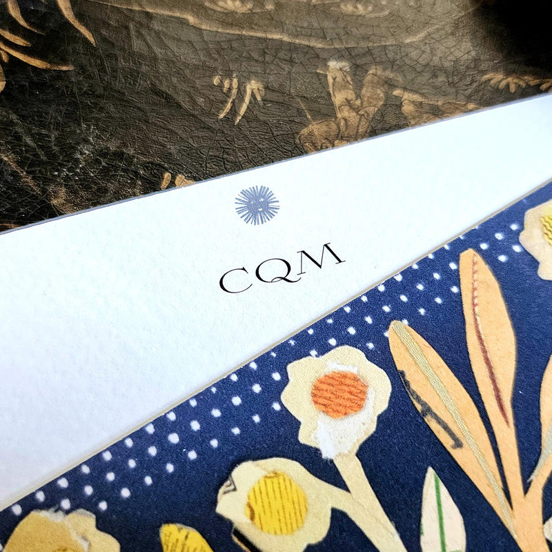 detail of the personalization of initials in the larger, fancier font printed at the top of the note card's marquee  just below sarah's small sun face logo