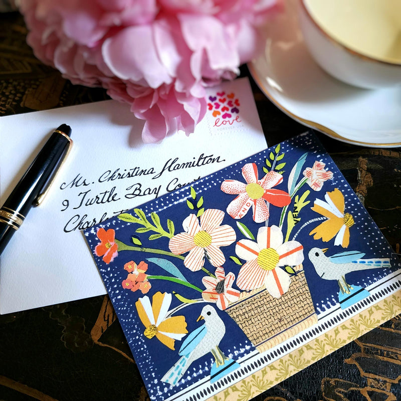 The Punctilious Mr. P x Sarah V Battle "Mixed Birds" Blue Bird fine note card set featuring collage reproductions of her original artwork, on chinoiserie table with Mr. P's I conic black and white anthemion print. montblanc fountain pen resting on top