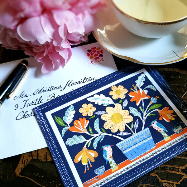 The Punctilious Mr. P x Sarah V Battle "Mixed Birds" Kingfisher fine note card set featuring collage reproductions of her original artwork, on chinoiserie table with Mr. P's I conic black and white anthemion print. montblanc fountain pen resting on top