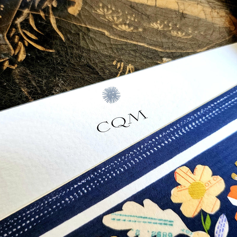 detail of the personalization of initials in the larger, fancier font printed at the top of the note card's marquee just below sarah's small sun face logo