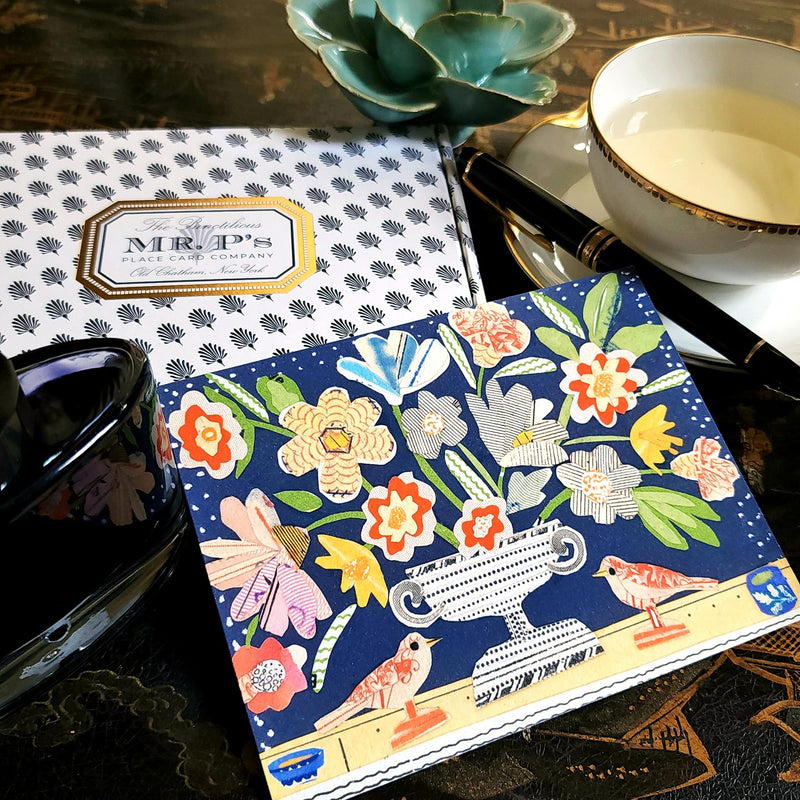 The Punctilious Mr. P x Sarah V Battle "Red Birds" fine note card set featuring collage reproductions of her original artwork, on chinoiserie table with Mr. P's I conic black and white anthemion print. montblanc fountain pen resting on top