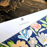 detail of the personalization of the name in the simple smaller font printed at the top of the note card's marquee just below sarah's small sun face logo