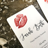 detail of The Punctilious Mr. P's Place Card Co. 'Kisses' Bistro size custom menu of lips on a black marble tabletop